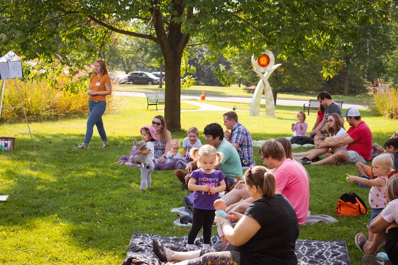 Families sitting outside during a Music Avenue class